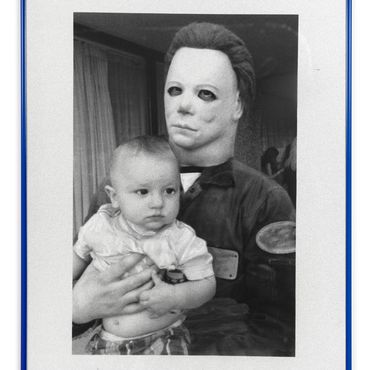 Schwarz/wei&szlig; Foto ein Kind wird von einer Person in Michael Meyers Maske gehalten
