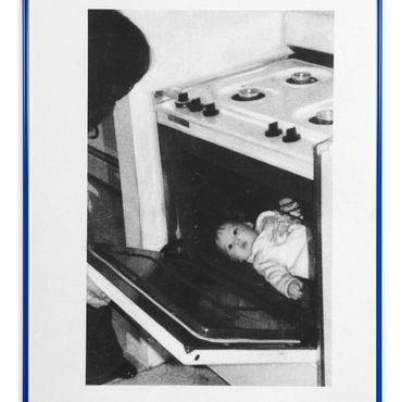 Schwarz/wei&szlig; Foto ein Baby liegt in einem Ofen