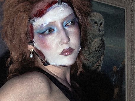 Woman with special effects make up, lokking like wearing twi faces