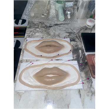 Special effect make-up is being prepared, two paisrs of fake lips ob a table