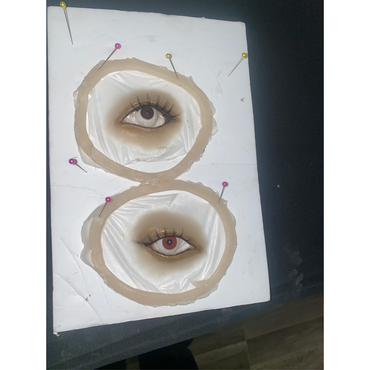 Special effect make-up is being prepared, two fake eyes on a table